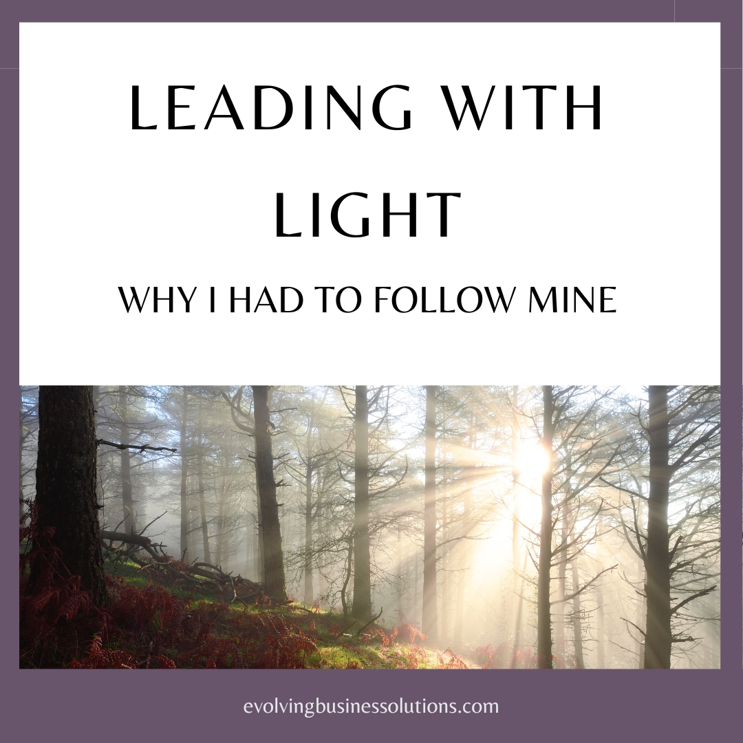 Sunlight beams through trees in a forest. Text overlay reads "Leading with Light - Why I Had to Follow Mine"